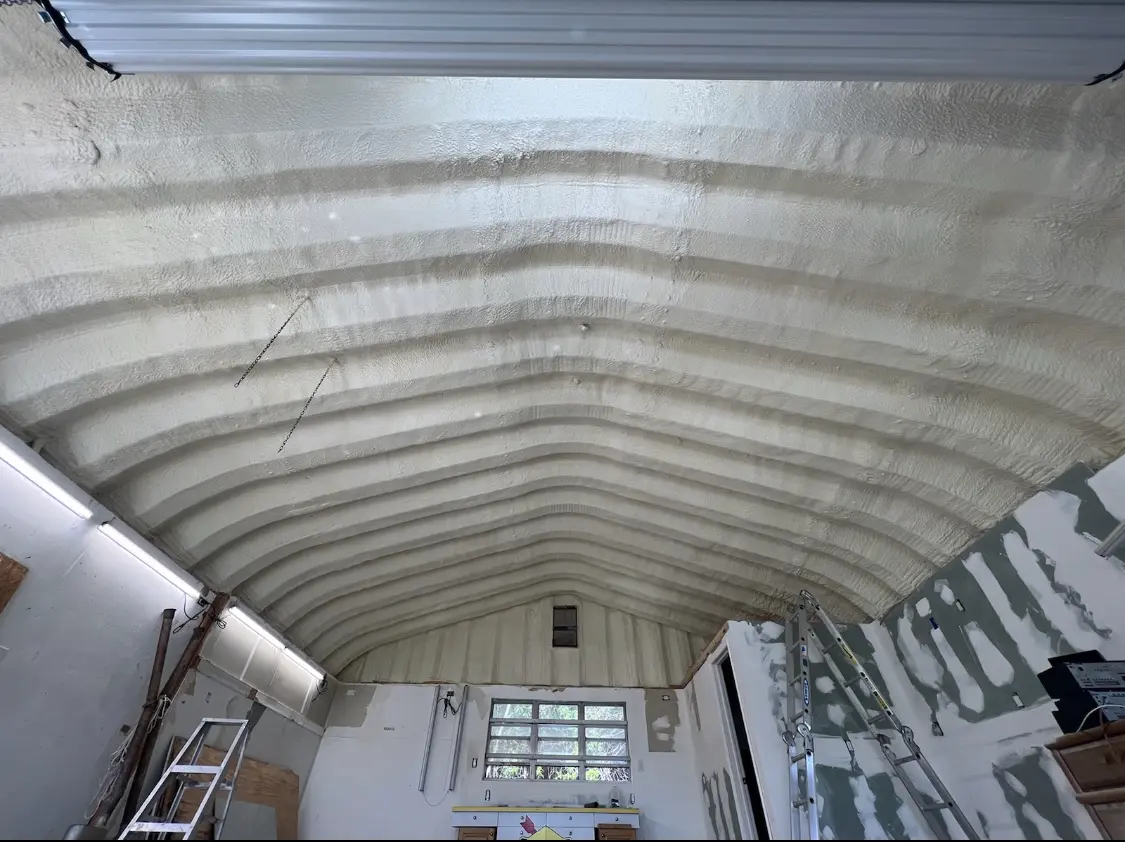 Spray polyurethane foam applied to the underside of a metal roof deck in West Point
